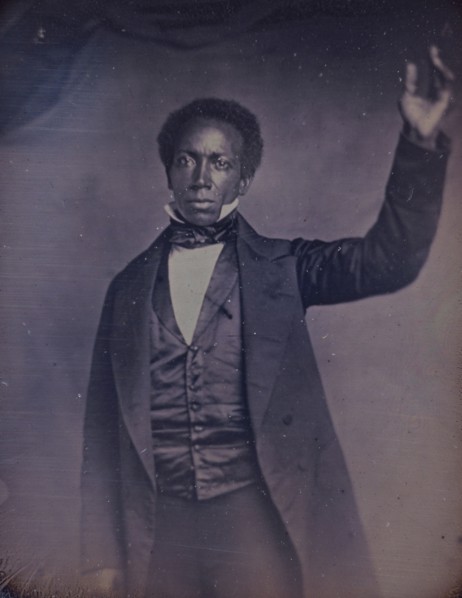 Edward J. Roye, three-quarter length portrait, standing, with hand raised, between 1856 and 1858. Creator: Augustus Washington.