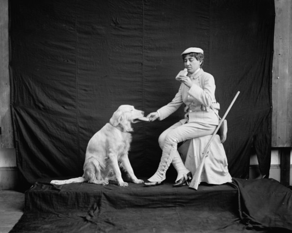 Billy and his mistress in hunting poses, between 1895 and 1910. Creator: Unknown.