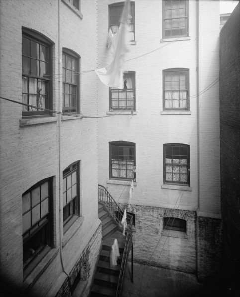 Court of tenement, New York City, between 1900 and 1910. Creator: Unknown.