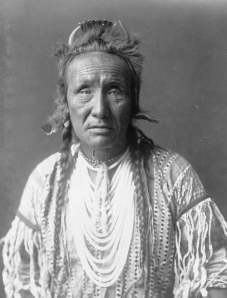 The Grizzly Bear, Piegan, half-length portrait, facing front, c1910. Creator: Edward Sheriff Curtis.
