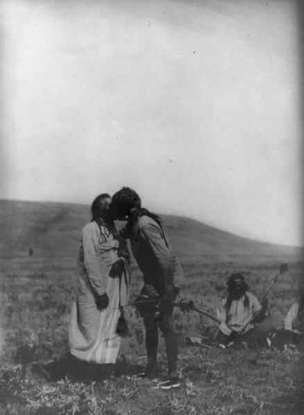 Atsina crazy dance-[A dancer kisses the grandfather], c1908. Creator: Edward Sheriff Curtis.