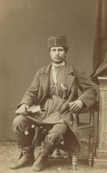 Full-length portrait of Persian man, seated, facing front, between 1870 and 1886. Creator: Unknown.