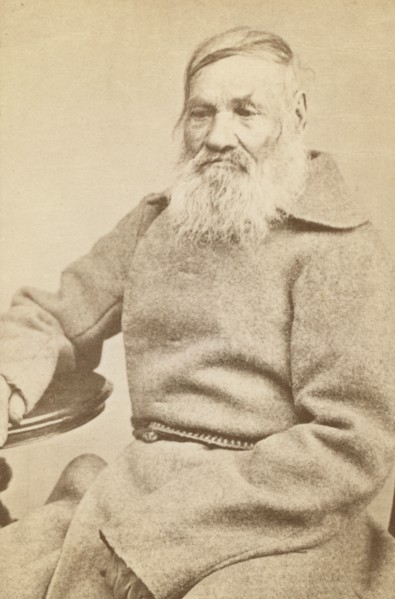 Three-quarter length portrait of an elderly convict, facing slightly left, between 1880 and 1886. Creator: Unknown.