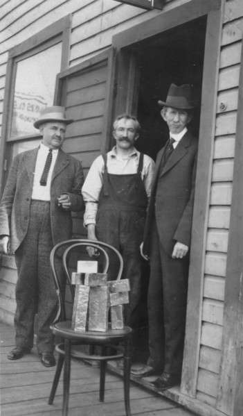 Delegate Wickersham, the assayer and Frank G. Carpenter in front of..., between c1900 and 1916. Creator: Unknown.