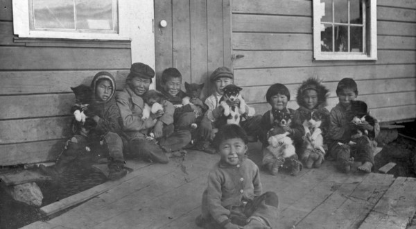 Eskimo children and puppies at the Moravian Mission Station, between c1900 and c1930. Creator: Unknown.