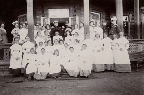 A group of students from the Maiden Institute with teachers on the porch of the dacha, 1900. Creators: I. A. Podgorbunskii, V. I. Podgorbunskii.
