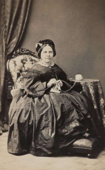 Business card, studio portrait of elderly woman knitting. (c1880s). Creator: Karolina Christianson.