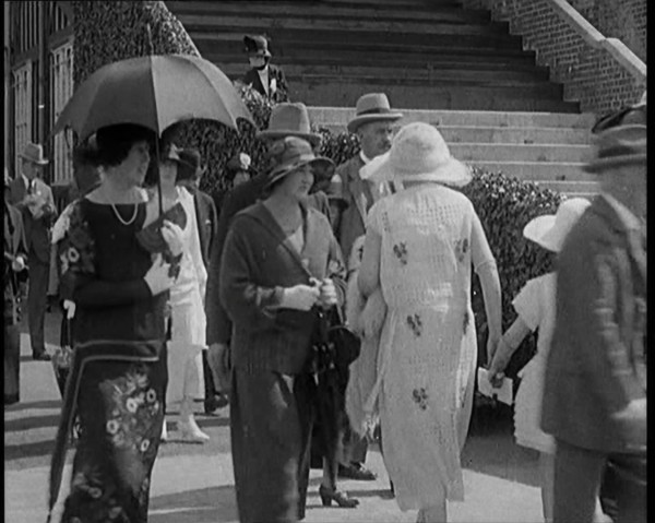 Civilians Walking Outdoors Wearing Evening Outfits and Hats, 1920. Creator: British Pathe Ltd.