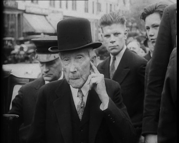 John D. Rockefeller Standing with Other People Next to a Car, 1933. Creator: British Pathe Ltd.