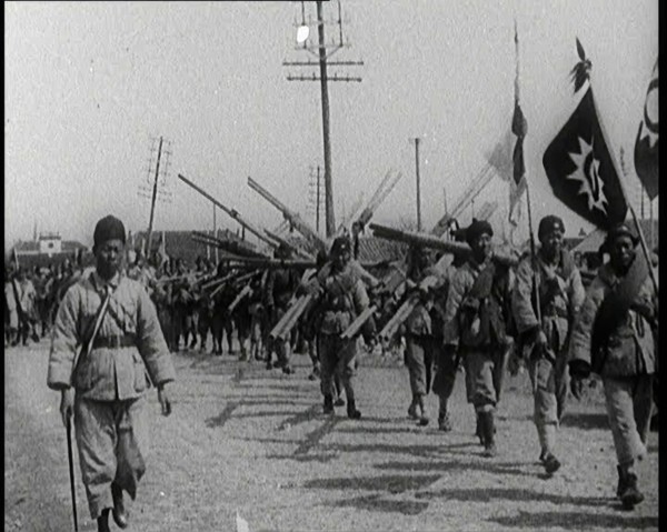 Chinese Soldiers Marching Carrying Flags and Other Equipment, 1920s. Creator: British Pathe Ltd.