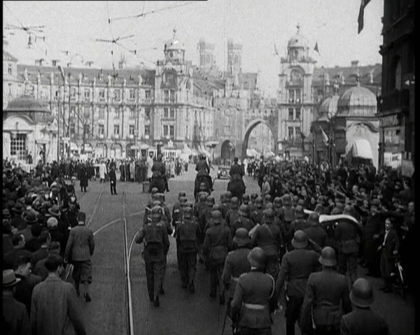 German Soldiers Marching Down a Street as a Crowd Watches, 1930s. Creator: British Pathe Ltd.