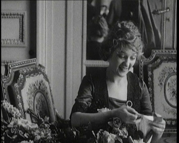 Mary Pickford Talking and Sitting Amongst Flowers in Paris, 1920. Creator: British Pathe Ltd.