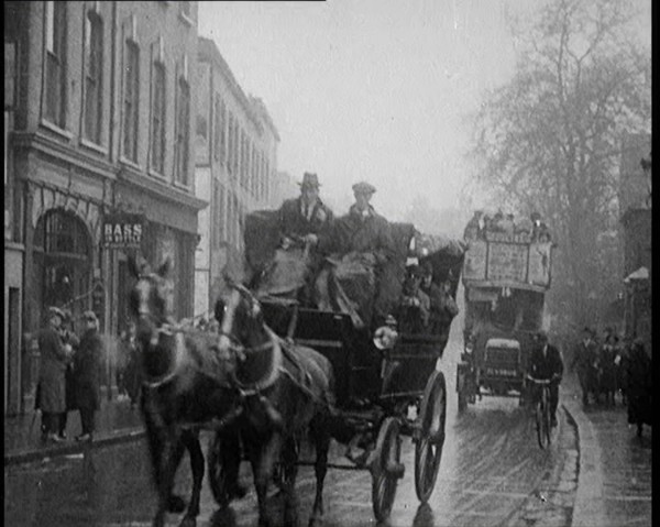 Vehicles Passing Along a Busy British Street, 1921. Creator: British Pathe Ltd.