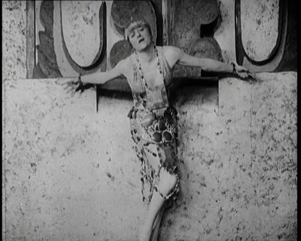 A Female Actor Chained to a Wall for a Performance, She Is Wearing a Glamorous Dress, 1922. Creator: British Pathe Ltd.