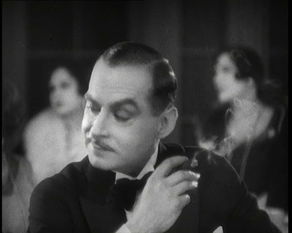Scene from the Film 'Champagne': a Male Actor in a Nightclub Smoking a Cigarette, 1920s. Creator: British Pathe Ltd.