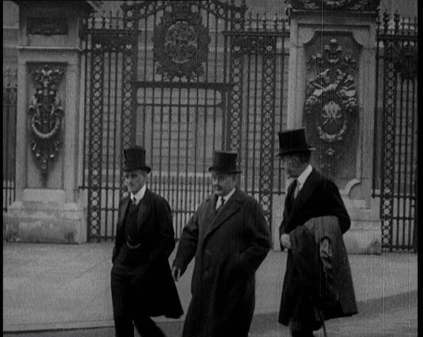 Three British Male Members of Parliament Walking Away from Buckingham Palace, 1924. Creator: British Pathe Ltd.