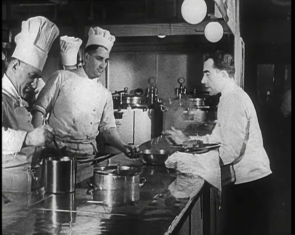 A Galley With Kitchen Staff Cooking and Waiters With Dishes on Board the 'Strength Through..., 1939. Creator: British Pathe Ltd.