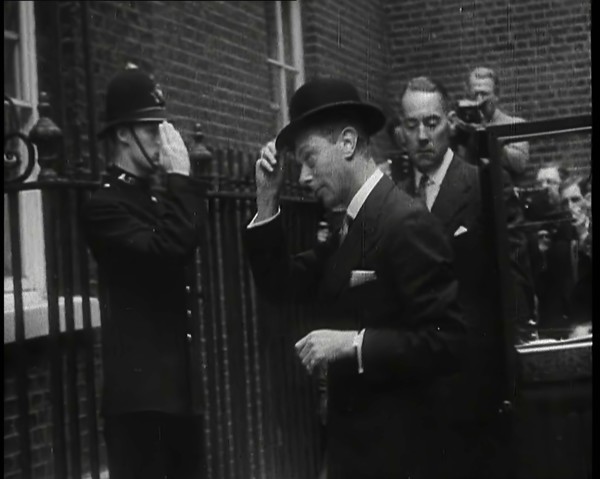 A Male British Police Officer Saluting King George VI, the British Monarch who is Exiting..., 1939. Creator: British Pathe Ltd.
