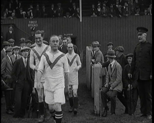 The Comedian George Robey Running Out Onto a Football Pitch in Front of a Large Crowd, 1920s. Creator: British Pathe Ltd.