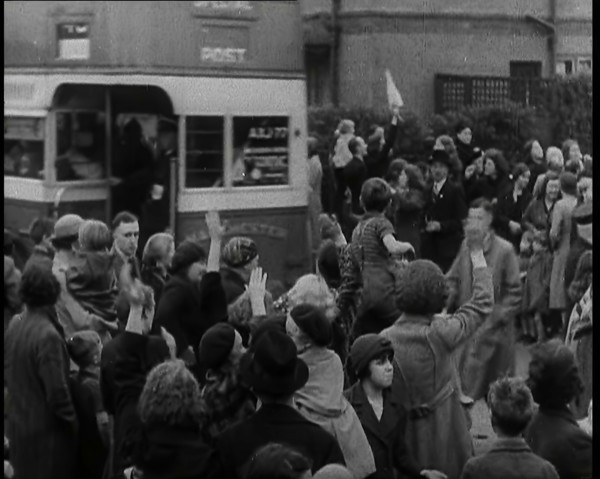 Women, Children, and Men Waving Goodbye to Children Being Evacuated by Bus, 1939. Creator: British Pathe Ltd.