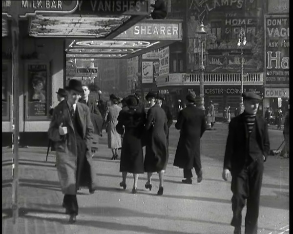 Men and Women Walking Through Leicester Square With the Leicester Corner Restaurant..., 1939. Creator: British Pathe Ltd.