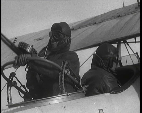 Male British Pilots On Board a Plane And Mounting a Machine Gun, 1920s. Creator: British Pathe Ltd.