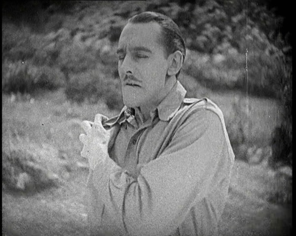 Scene from the Feature Film 'The White Sheik'. An Actor Portraying a Male Soldier Grabbing..., 1920s Creator: British Pathe Ltd.