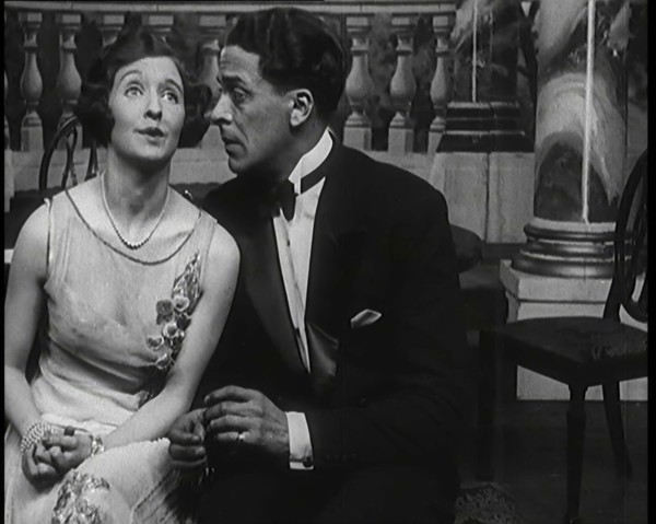 Jack Buchanan and June Knight Sitting on a Bench Together. Buchanan Looking Uncomfortable...,1920s Creator: British Pathe Ltd.