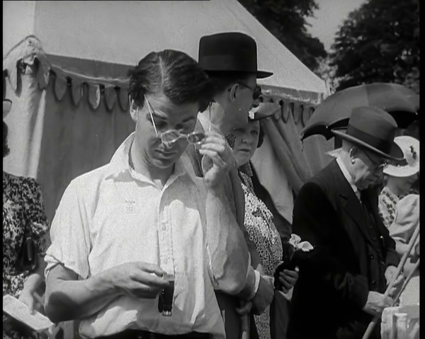 Emlyn Williams, Actor, Timing Punters by the 'Fishing for Fizz' Stall at  the Theatrical..., 1939. Creator: British Pathe Ltd.