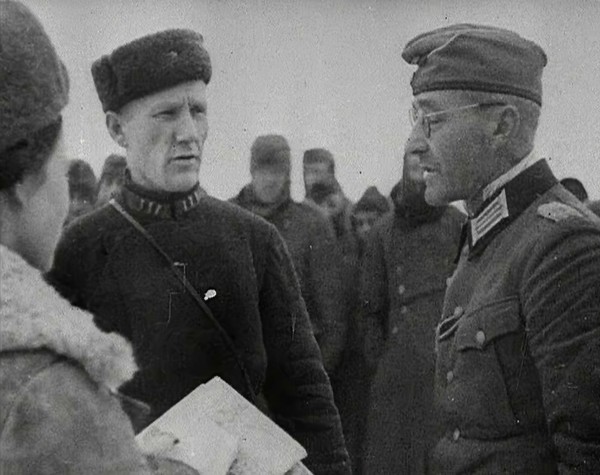 Two Russian Soldiers Talking to a German Prisoner of War, 1941. Creator: British Pathe Ltd.