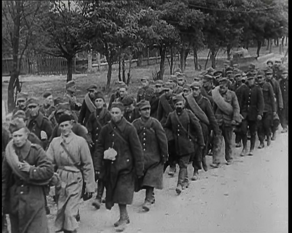Male Polish Soldiers Walking Along an Unpaved Road Beside a Line of Trees With Fences Beyond, 1939. Creator: British Pathe Ltd.