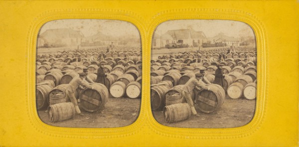 Men rolling a barrel in a field of barrels, 1860s. Creator: E Lamy.