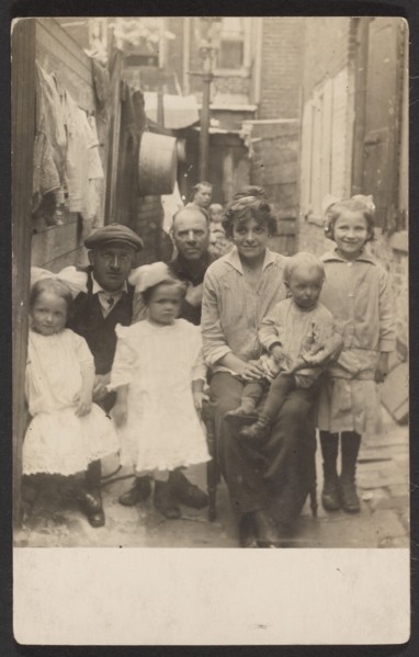 Family portrait in tenement alley, about 1913-1925. Creator: John Frank Keith.