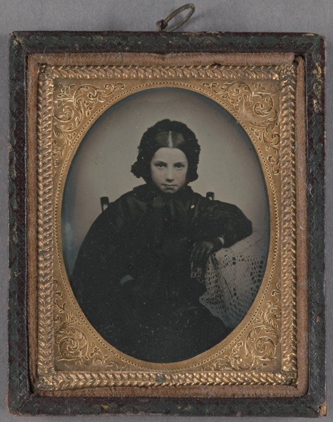 Portrait of a young girl dressed in dark clothes, wearing dark gloves, about 1860. Creator: Unknown.
