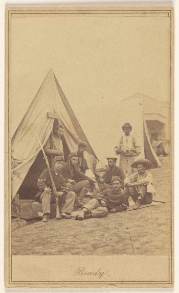 Group of seven soldiers and one black servant at a campsite, about 1862. Creator: Mathew Brady.