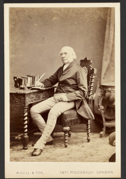 Portrait of man holding quill, about 1879-1885. Creator: Maull & Fox.