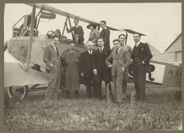 Group portrait in front of plane, 1915-1930. Creator: Fédèle Azari.