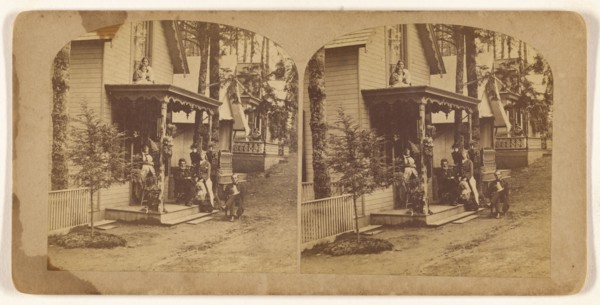 Family portrait posed on front porch of house, about 1865. Creator: Unknown.