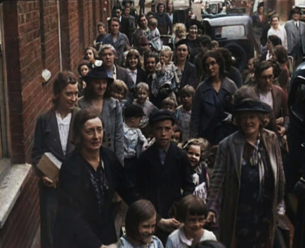 British Women and Child Evacuees Walking Along the Pavement of a Residential Street Next..., 1939. Creator: British Pathe Ltd.