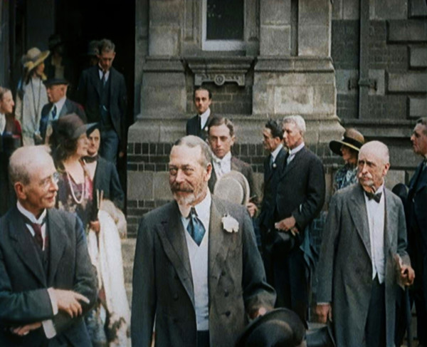 King George V Accompanied by a Group of Officials Emerging from a Building , 1924. Creator: British Pathe Ltd.
