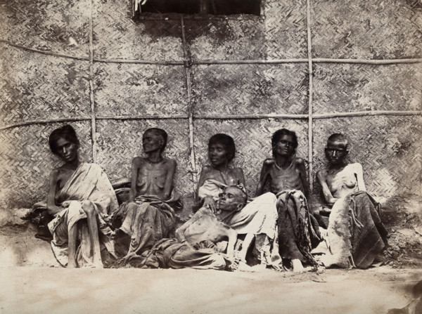 Famine in Mysore, India: six emaciated women, five sitting and one leaning on another's lap, 1876-78 Creator: Willoughby Wallace Hooper.
