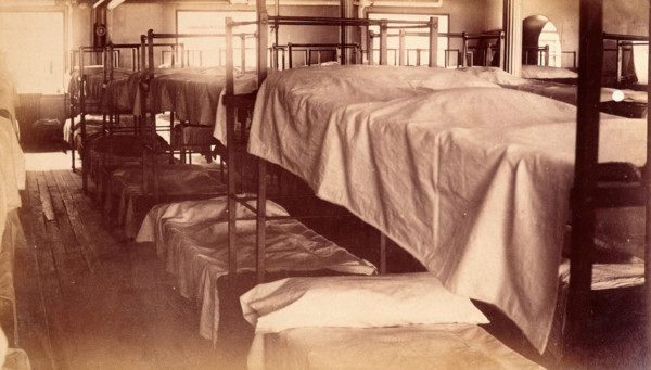 Bellevue Hospital, New York City: a dormitory with bunk beds, 1885-1898. Creator: Unknown.