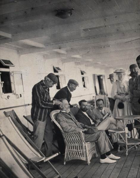 Members of the British Association playing at phrenology on board a ship on its way to..., 1905. Creator: James Thomson Bottomley.