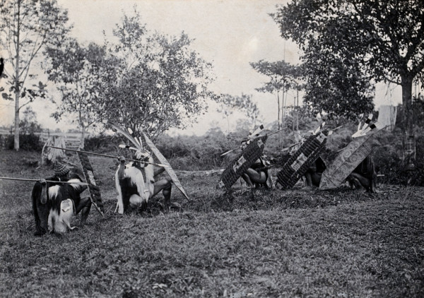 Sarawak: five Kenyah warriors in a warfare ritual, c1900. Creator: Unknown.