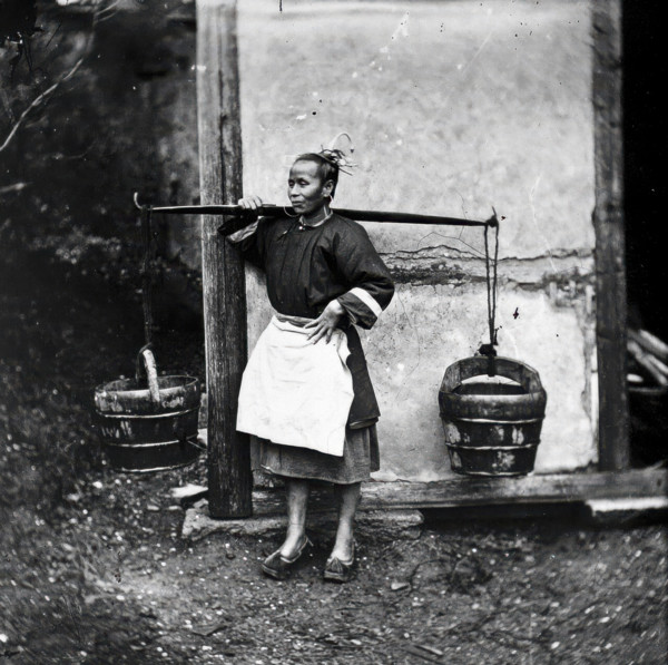 Foochow, Fukien province, China: a woman carrying buckets of night-soil, 1869 (1981). Creator: John Thomson.