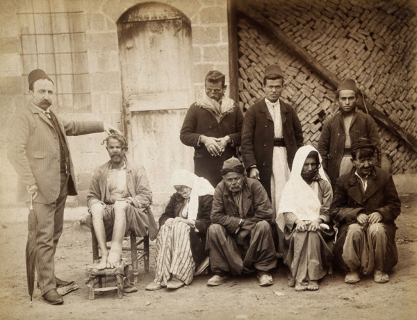 A group of people with leprosy in Jerusalem: a man in a striped suit..., c1890s. Creator: Unknown.