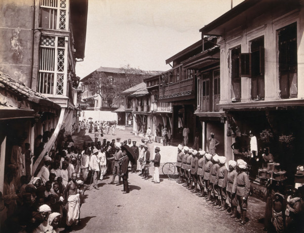 A group of officials making a visit to a house in Bombay, suspected of holding people with..., 1896. Creator: Unknown.