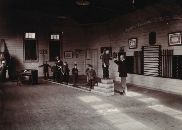 Metropolitan Lunatic Asylum, Kew, Victoria (Australia): boys walking along a ladder laid upon... Creator: Unknown.