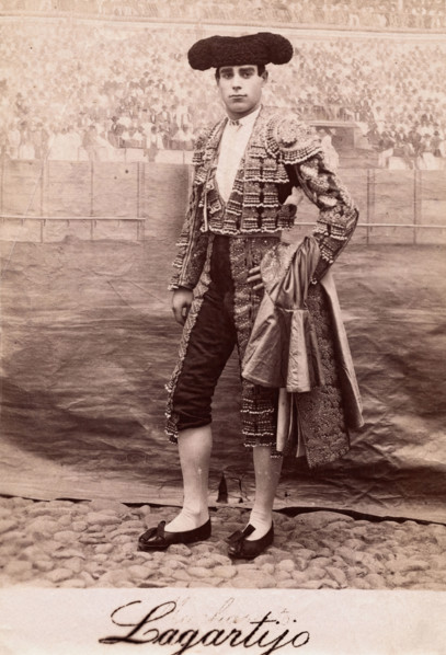 A bullfighter, Rafael Molina Sanchez "Lagartijo", posing in front of a painted back..., c1870s. Creator: Unknown.