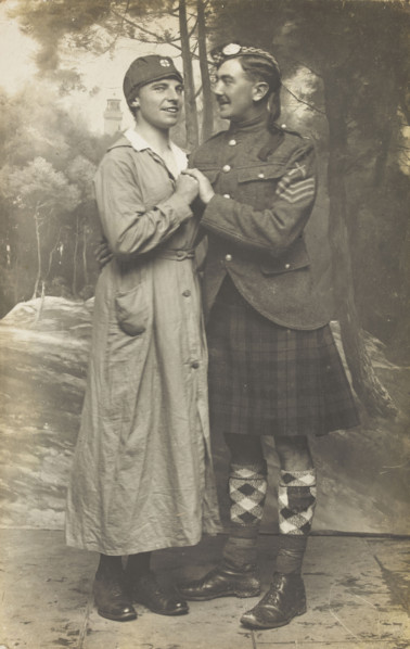 Two soldiers playing in a military concert party embrace: one is in drag and the ..., [1910-1919]. Creator: Unknown.